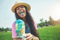 The best ice creams make your tongue blue. an attractive young woman enjoying an ice cream in the park.