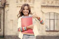 The best lesson ever. Happy little child giving thumbs up for literature lesson. Small girl smiling with lesson books Royalty Free Stock Photo