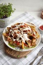 Baked potato with greens, garlic and sauces on a white plate Royalty Free Stock Photo