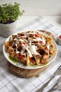 Baked potato with greens, garlic and sauces on a white plate Royalty Free Stock Photo