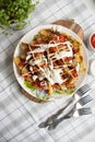 Baked potato with greens, garlic and sauces on a white plate Royalty Free Stock Photo