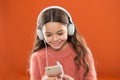 Best music apps for free. Enjoy perfect sound. Girl child listen music modern headphones and smartphone. Listen for free