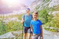 Best Norway hike. Cute boy and his mother with hiking equipment in the mountains