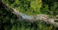 Top down aerial view of the folowing dron along the wilderness, the rivers along the cliff