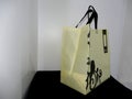 Best Polypropylene Fabric yellow Bag, Shopping printed bag on black table Royalty Free Stock Photo