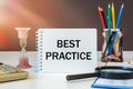 BEST PRACTIICE is written on a notepad on an office desk Royalty Free Stock Photo