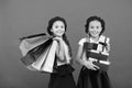 Best price. Visit shopping mall. Kids girls hold bunch shopping bags or birthday gifts packages. Dreams come true. Happy Royalty Free Stock Photo