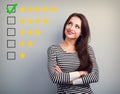The best rating, evaluation. Business confident happy woman voting to five yellow star to increase ranking. On grey background Royalty Free Stock Photo
