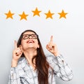 The best rating, evaluation. Business confident happy woman voting the hand on five yellow star to increase ranking. On grey Royalty Free Stock Photo