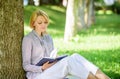 Best self help books for women. Books every girl should read. Girl concentrated sit park lean tree trunk read book Royalty Free Stock Photo