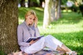 Best self help books for women. Girl concentrated sit park lean tree trunk read book. Reading inspiring books Royalty Free Stock Photo