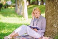 Best self help books for women. Girl concentrated sit park lean tree trunk read book. Reading inspiring books Royalty Free Stock Photo