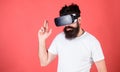 Best shooters for VR. Man bearded hipster with virtual reality headset on red background. Man hand gesture as gun play Royalty Free Stock Photo