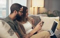 The best site for budget conscious shoppers. a young couple using a laptop and credit card on the sofa at home.