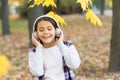 Best song about fall. Cute small child enjoy song playing in headphones. Adorable little girl sing along to song. Autumn