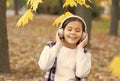 Best song about fall. Cute small child enjoy song playing in headphones. Adorable little girl sing along to song. Autumn Royalty Free Stock Photo