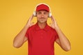 Best sounding headphones. Happy guy wear headphones yellow background. Handsome man listen to music in headphones. Using Royalty Free Stock Photo