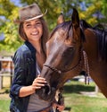 The best steed a woman could want. Portrait of a young cowgirl standing with her horse. Royalty Free Stock Photo