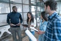 Best team ever. Group of young multi ethnic business people in smart casual wear working together and smiling while standing in Royalty Free Stock Photo