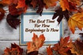 The Best Time For New Beginnings Is Now text with maple leaf decoration on wooden background Royalty Free Stock Photo
