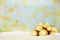 The best time of the year. Shot of a group of golden Christmas ornaments against a textured background.