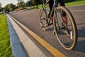 Best vehicle. Cropped detailed shot of cyclist riding racing bike along asphalt road in park on a warm sunny day Royalty Free Stock Photo