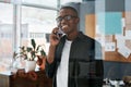 Best way to wake up quit dreaming. a young businessman using his cellphone in a modern office.