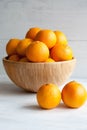 Plain orange mandarins on a grey background