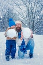 Best winter game for happy family. Happy father and son making snowman in the snow. Handmade funny snow man. Happy Royalty Free Stock Photo