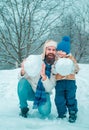 Best winter game for happy family. Happy father and son making snowman in the snow. Handmade funny snow man. Happy Royalty Free Stock Photo