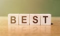 BEST word written on wooden blocks on wooden table. Concept for your design Royalty Free Stock Photo