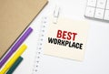 BEST WORKPLACE Notebook on laptop keyboard, on light background Royalty Free Stock Photo