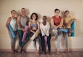 This is the best yoga group. Full length portrait of a diverse group of yogis sitting together and bonding after an
