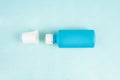 A Betadine bottle with its cap opened is placed on a light blue background, creating a clean and refreshing look Royalty Free Stock Photo