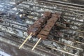 Betamax, or coagulated pork blood being cooked on a charcoal grill. It is an exotic Filipino street food