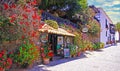 Beautiful romantic restaurant building front, roof top terrace, colorful flowers in clay pots, empty street