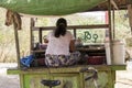 Woman seating on a Betel nut kiosk