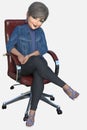 Pretty middle-aged boss woman sitting on a rolling desk chair, smiling at the camera on an isolated white background Royalty Free Stock Photo