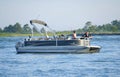 Anglers on the pontoon boat fishing for flounder near Indian River Inlet in the