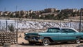 BETHLEHEM, PALESTIN Oldsmobile Delta 88 vintage car in front of Israeli West Bank Barrier Royalty Free Stock Photo