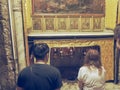 BETHLEHEM, PALESTINE- SEPTEMBER, 22, 2016: pilgrims kneel at the star in the church of the nativity in bethlehem Royalty Free Stock Photo