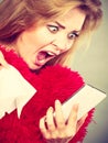 Shocked heartbroken woman looking at her phone Royalty Free Stock Photo