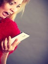 Shocked heartbroken woman looking at her phone Royalty Free Stock Photo