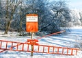 Betreten des Eises verboten, Warning sign with rescue equipment in winter at the pond