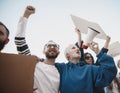 Group of activists giving slogans in a rally. Men and women marching together in a protest in the city.