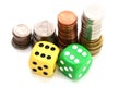 Betting all in concept with ladder of stacked coins and a pair of plastic dice