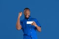 Monochrome portrait of young african-american man on blue studio background Royalty Free Stock Photo