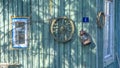 Betty lamp and spinning wheel in the background of the old log-house wall with sign nomber one. Rural retro still life. Royalty Free Stock Photo