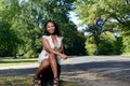 Beuatiful African American woman sitting next to road Royalty Free Stock Photo