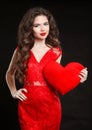 Beuatiful girl with Valentine heart wearing in red dress isolate